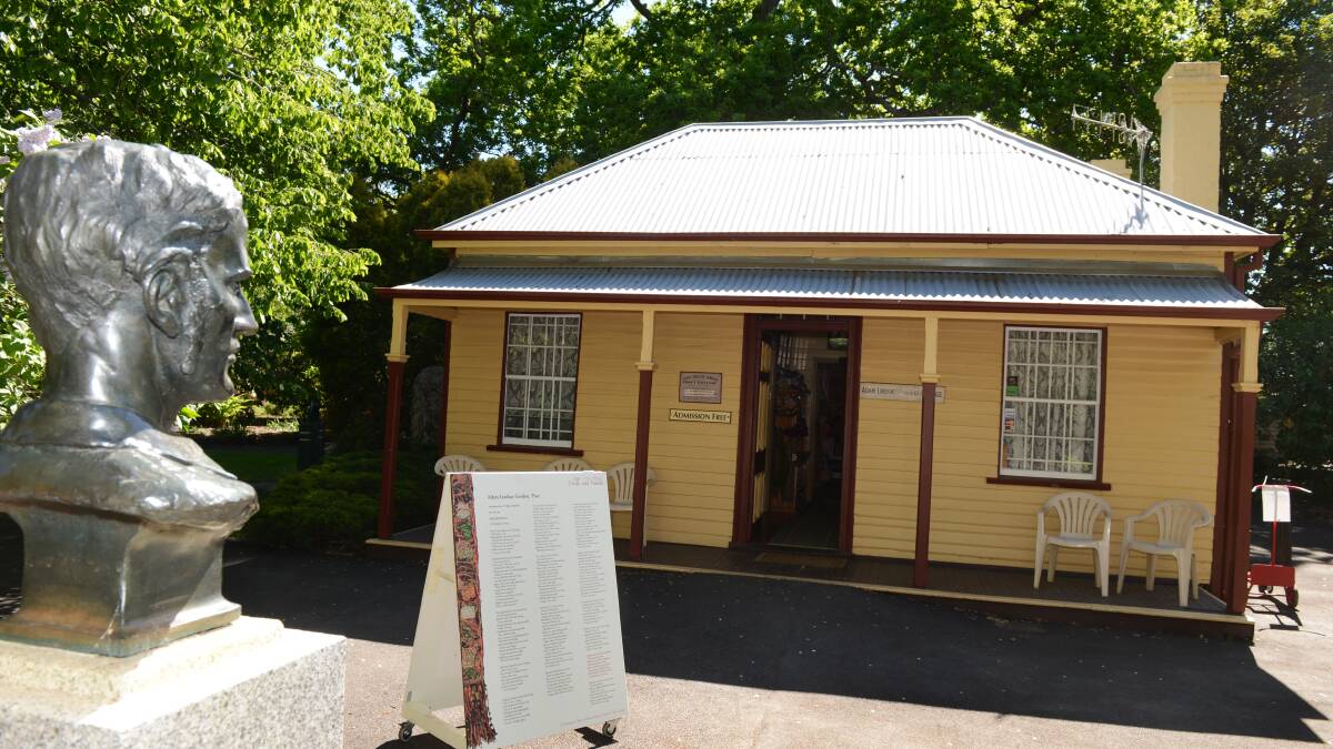 Adam Lindsay Gordon's cottage in Ballarat's Botanical Gardens, with his bust in the foreground.