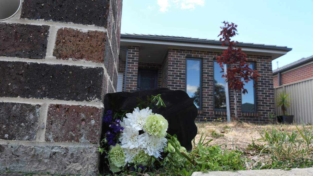 FLORAL TRIBUTE: Flowers lie outside Ms Farrell's Horwood Drive home. Picture: Lachlan Bence.