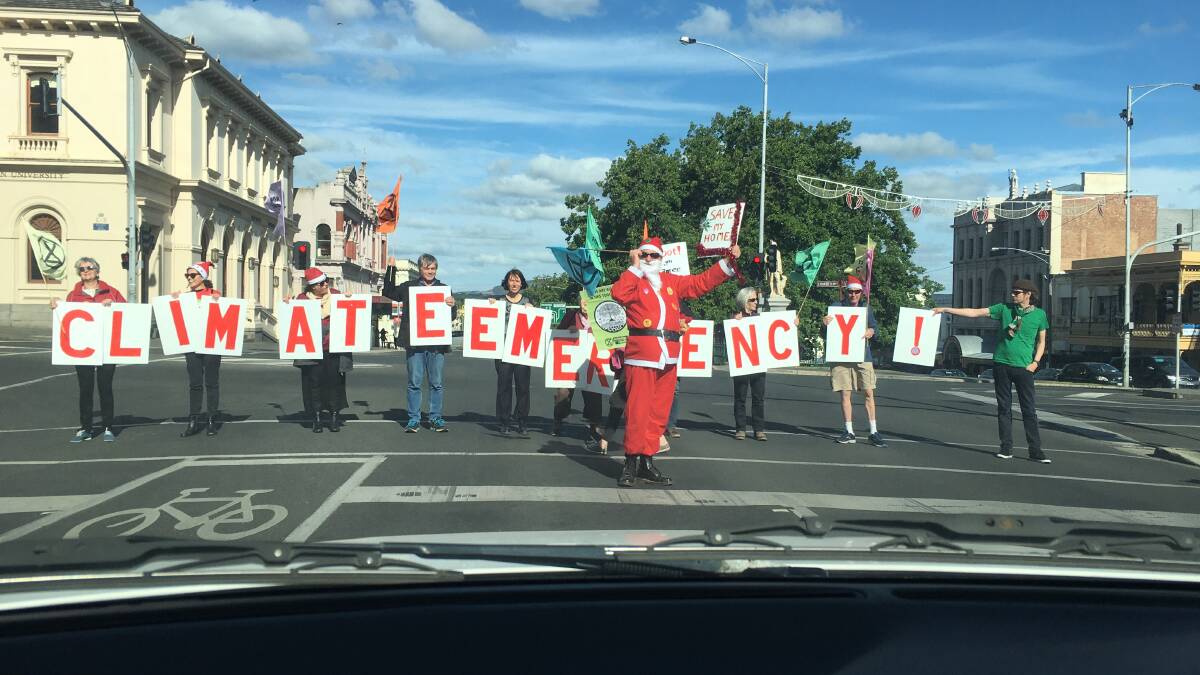 VIEW FROM THE FRONT: The Christmas protest as the activists line up in front of the traffic on Sturt Street. 