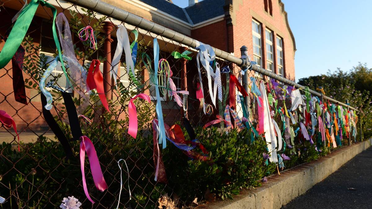 A photo from the time of the Royal Commission showing ribbons tied to the fence of St Alipius Parish School in support of survivors of sexual abuse. 