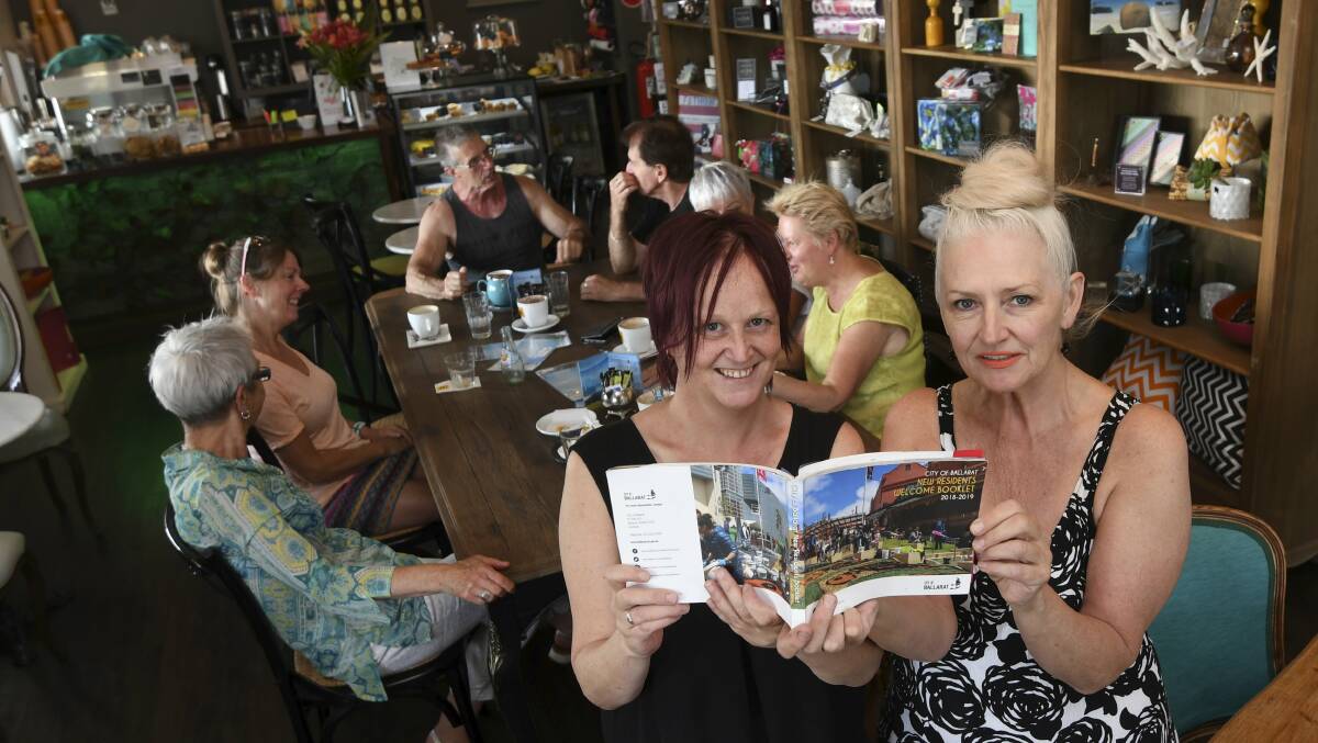 BY THE BOOK: Lesley Atkins and Veronica Darcy at the Eau Verte Cafe, which is among hundreds of Ballarat businesses with offers in the booklet. Picture: Lachlan Bence