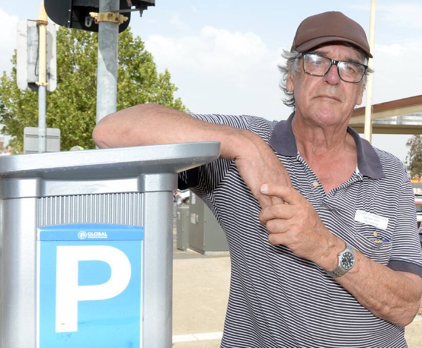 NOT MEETING NEEDS: Geoff Pitt stands by one of the new meters. Picture: Kate Healy. 