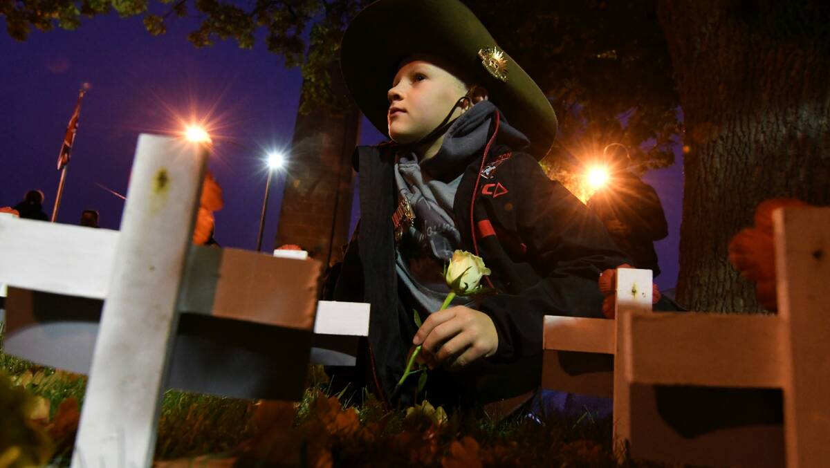 RESPECTFUL: Toby Carroll, 7, by his grandfather's commemorative cross at the Cenotaph in Sturt Street. Picture: Lachlan Bence.