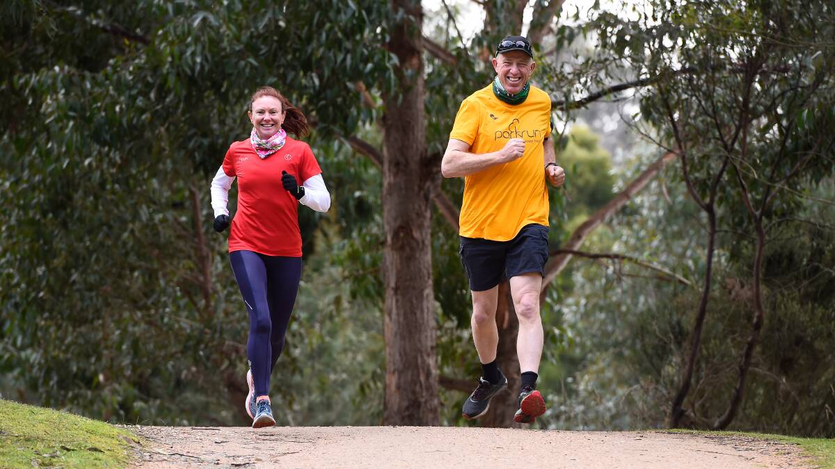 Parkrunners Kylie Mayne and Bruce Purdie use the Wallaby Track trail, which runs beside the Yarrowee, during lockdown. Photo: Adam Trafford.