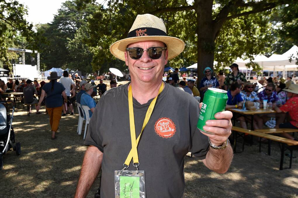 HAPPY MAN: Festival director Ric Dexter grants himself a smile and a drink after a stressful build-up to the festival, which took place in the North Gardens on Saturday. 