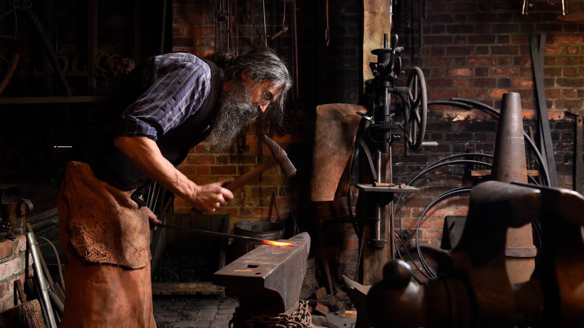 FORGOTTEN SKILLS: Sovereign Hill blacksmith Justin McCann demonstrates one of the skills frequently on show at the attraction. Picture: Adam Trafford. 
