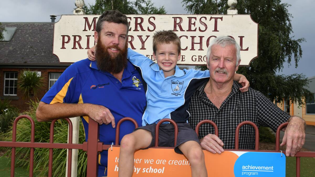 KEEPING IT IN THE FAMILY: Three generations of Miners Rest Primary School pupils, including Leon Davey (left), Oliver Davey and his grandfather Michael Davey. Picture: Lachlan Bence