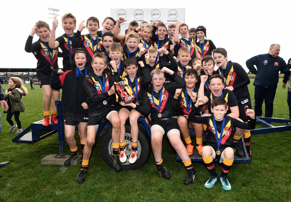 FOLLOW: Bacchus Marsh celebrates after winning the under-11 seniors BFL grand final. Picture: Adam trafford 
