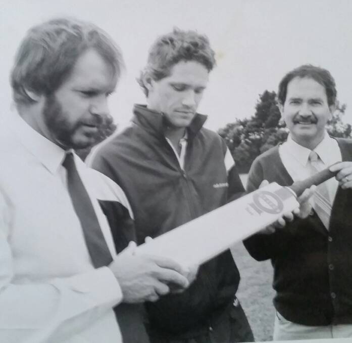 MEMORIES: Dean Jones (middle) presents a signed bat to Phillip Mann and Peter Morey after the passing of Ballarat crickter Graeme Lowe in 1987.