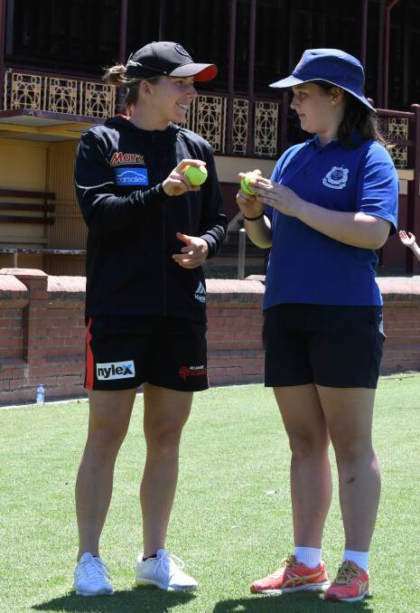 RELAXED: Melbourne Renegades leg-spin bowler Georgia Wareham coaches a St Columbas Grade 6 Student at a clinic at Eastern Oval on Friday. Picture: Lachlan Bence