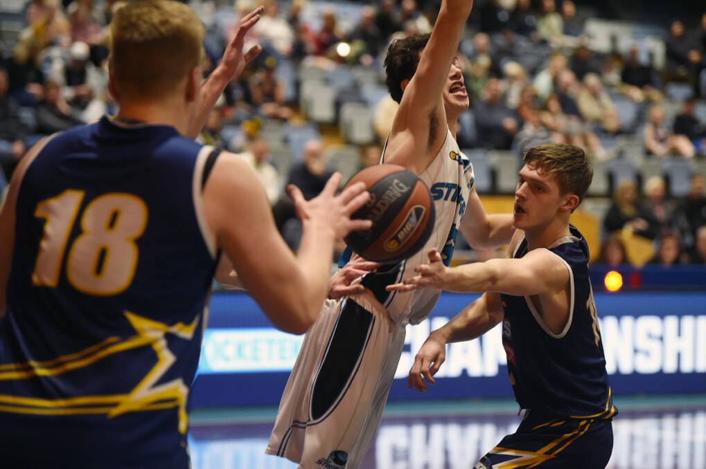 CLUTCH: Zach Dunmore feeds Amos Brooks for a basket in the final quarter of the Ballarat Miners' thrilling victory over Corio Bay. Picture: Kate Healy 
