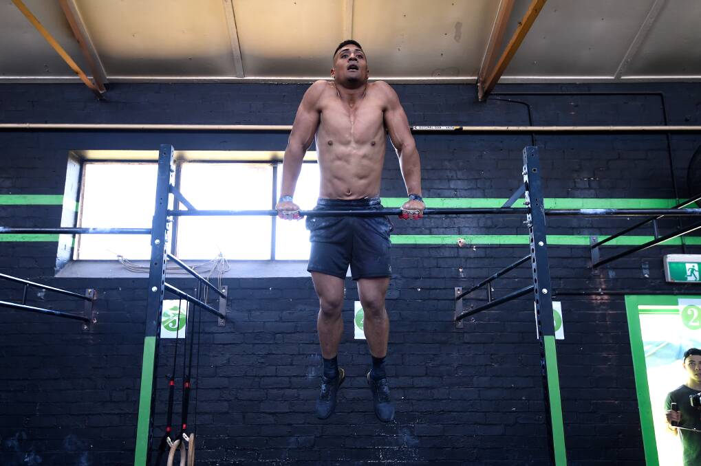 STRONG: Toni Fatafehi displays his upper-body ability at the PerFit Health and Wellness PerFit Throwdown Cross-fit event. Picture: Adam Trafford