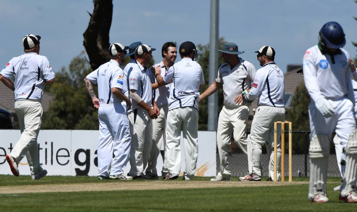HOW'S THAT: Mt Clear celebrate after taking a hard-earned wicket against Ballarat-Redan on Saturday. 