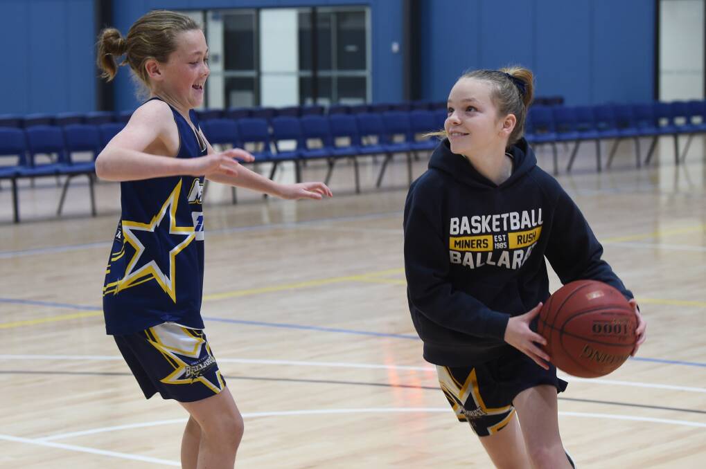 EXCITED: Aislinn McCarthy and Taj Bowman play one-on-one ahead of the under-14 National Club Championships in Ballarat. Picture: Kate Healy 