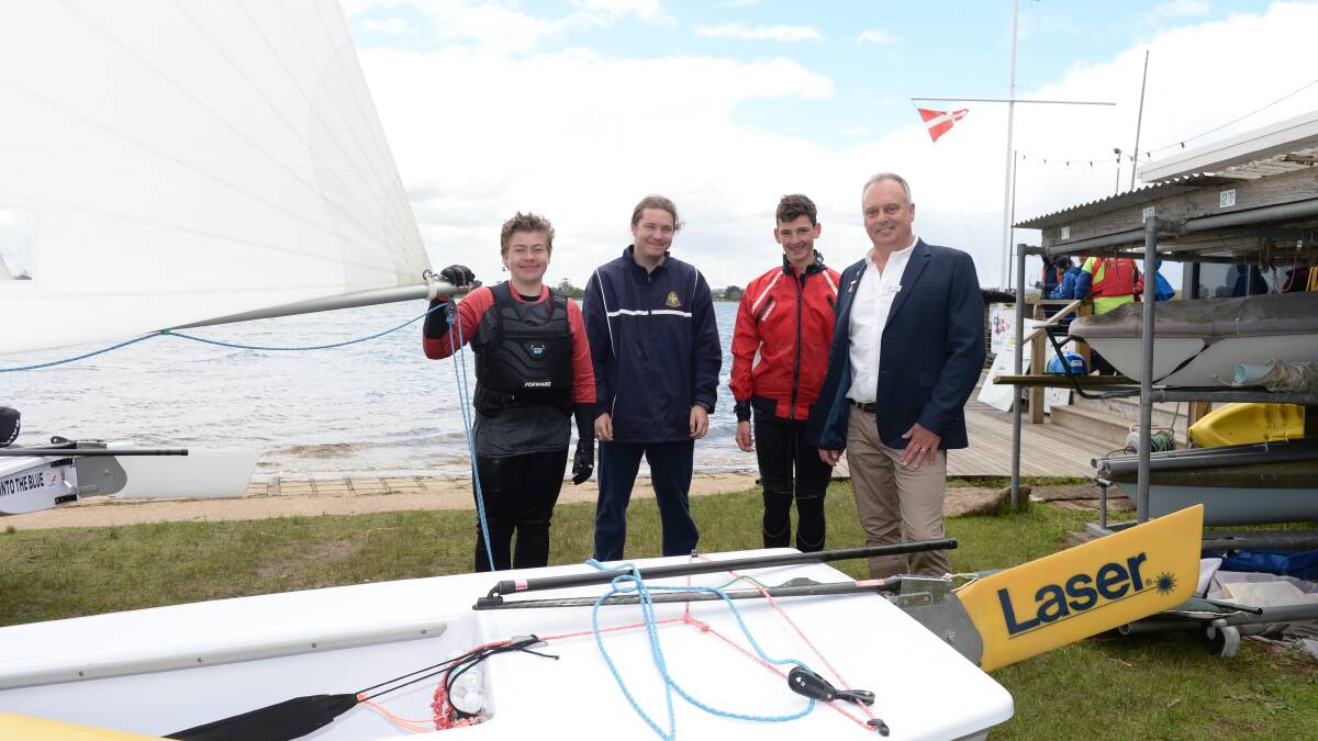 HOIST: Commodore Russell Hawkes with junior sailors with Alex Hughes, Joel Harbour and Cooper Brown to mark the opening of sailing season. Picture: Kate Healy