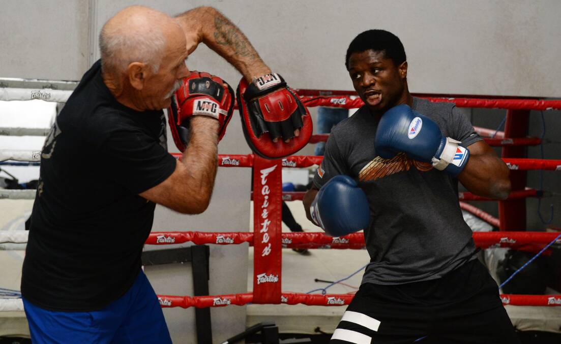 READY TO RUMBLE: Victor Nagbe spars with trainer Tony Salta ahead of upcoming bout with Fano Kori on October 12. Picture: Kate Healy 