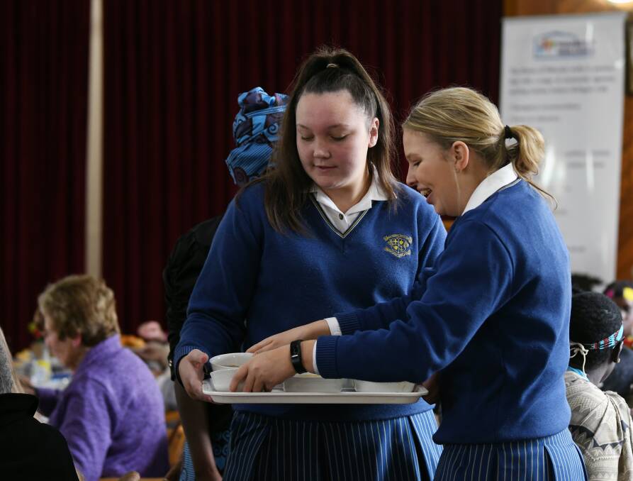 SERVICE: Loreto College students, Annie Quinlan and Teele Hart, help serve during the  House of Welcome soup luncheon at Nazareth House Hall. Picture: Kate Healy