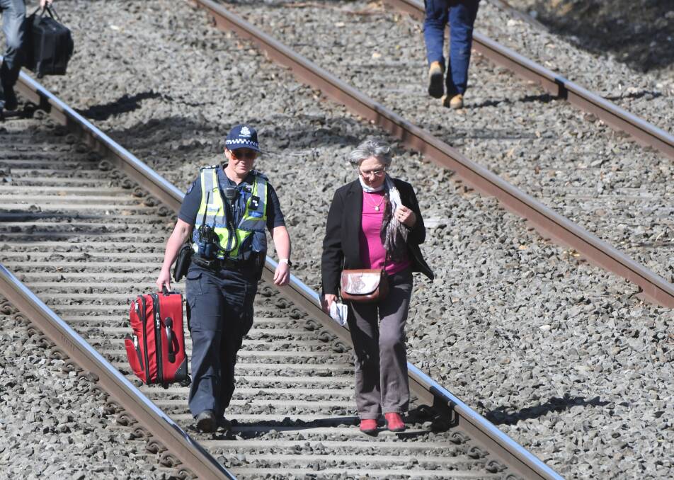 Passengers are escorted off the V/Line train following the fatality at Ballarat East. Picture: Kate Healy