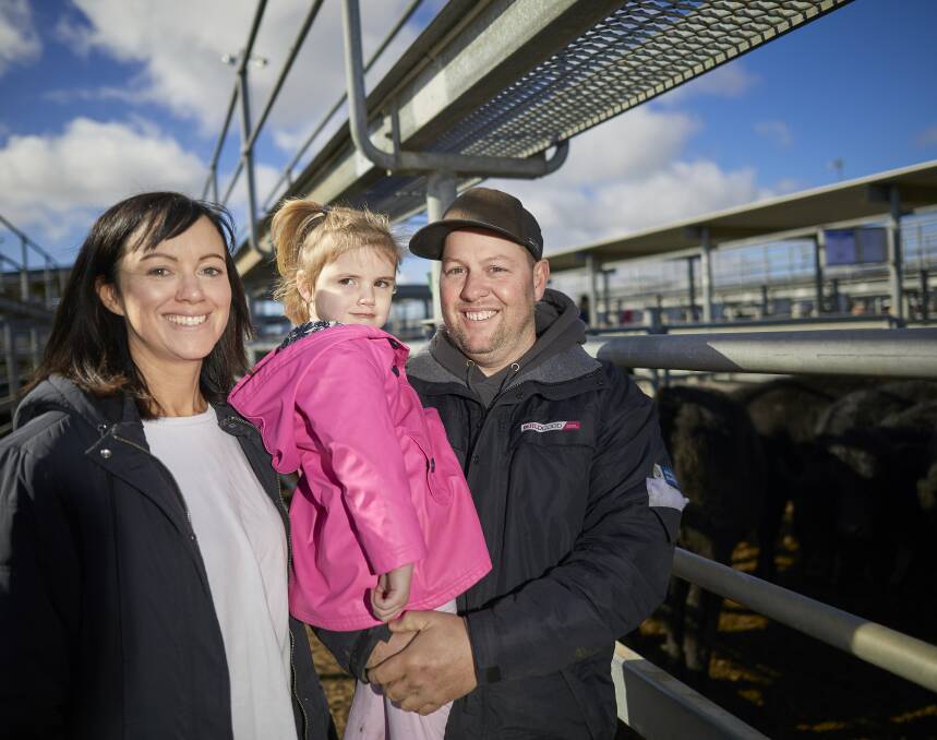HAPPY: Grazier Richard Goodwin with his family, Rachael Goodwin and June, 3, at the special cattle sale on Friday, held at the old saleyards. Photo: Luka Kauzlaric
