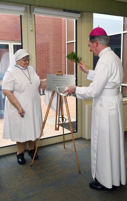 OFFICIAL OPENING: Sister Clare Breen and Bishop Paul Bird unveil the plaque to mark the opening of the newly completed Basil Wing at Nazareth Care. Picture: Kate Healy