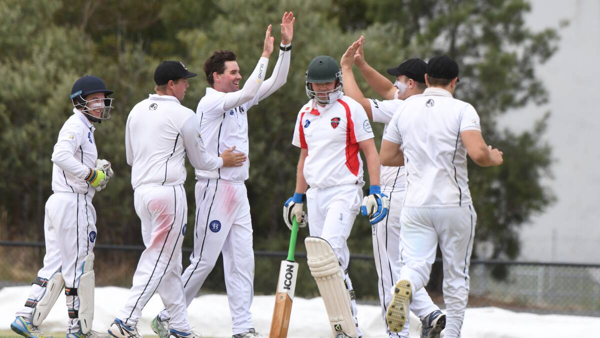 ANOTHER ONE: It is high fives all round as Jason Crosbie picjs up one of his five wickets for the day. Picture: Kate Healy