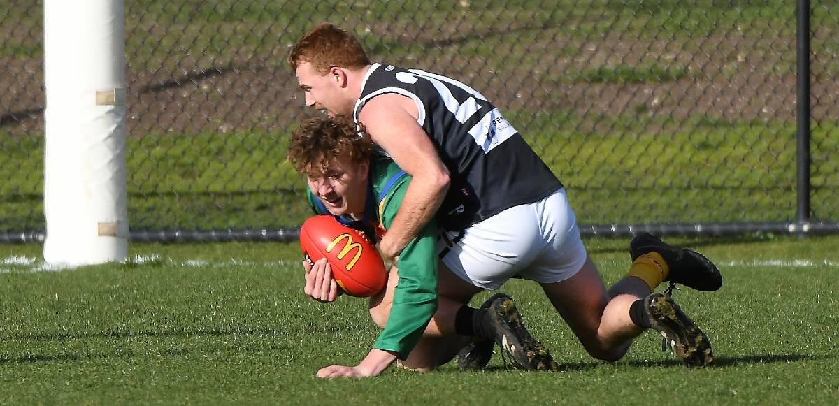 Mitch Gilbert (North Ballarat City) lays a bone-shaking tackle on Jacob Lohmann (Lake Wendouree) at Wendouree on Saturday. Picture: Lachlan Bence
