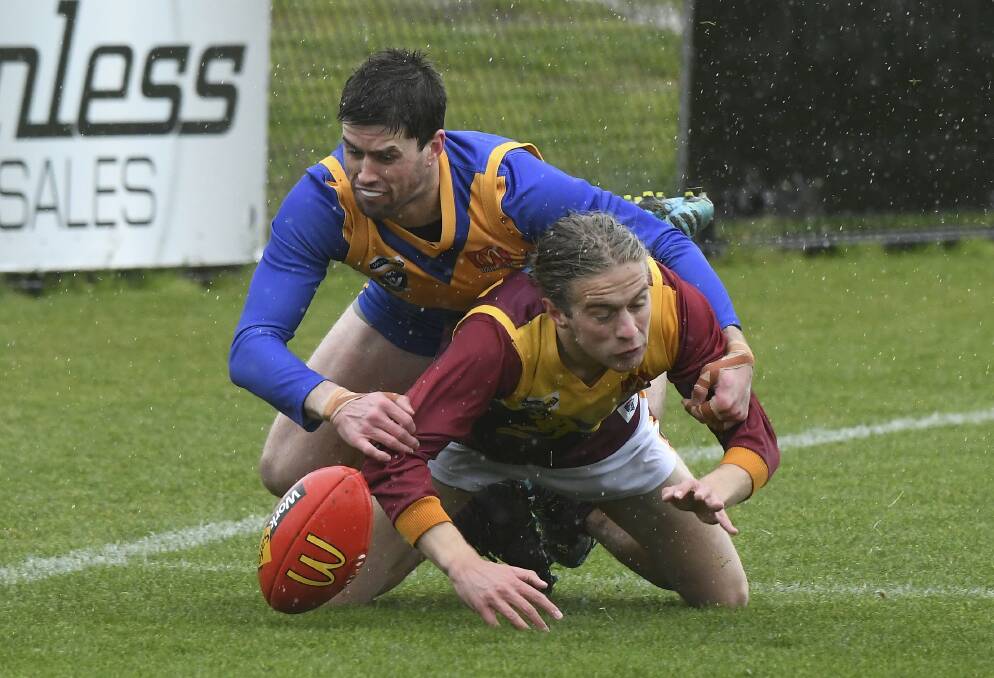 GOTCHA: Cooper Atchison (Redan) swamped by Sebastopol defender Tony Lockyer in the second semi-final at Wendouree on Sunday. Picture: Lachloan Bence 