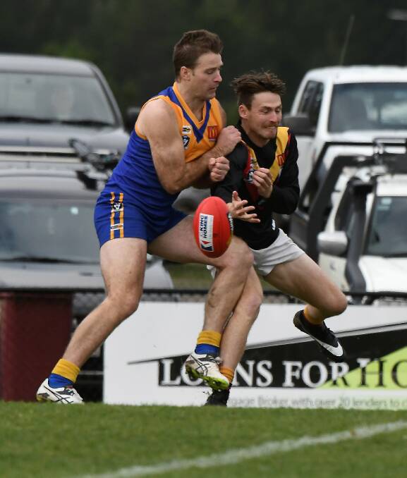 Tim Hughes (Bacchus Marsh) gets caught in a miss-match with Sebastopol ruckman/forward Tom Petersen at Marty Busch Reserve on Saturday. Picture: Lachlan Bence