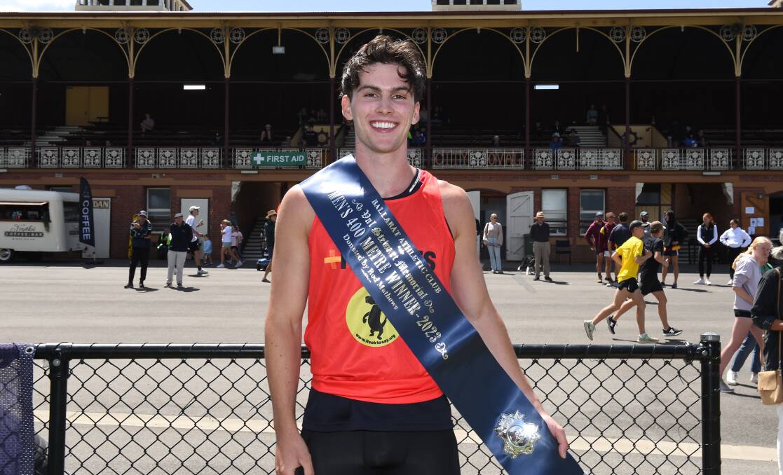 Elijah Cross proudly shows off his open 400m winner's sash at the Ballarat City Oval on Sunday. Picture by Adam Trafford.