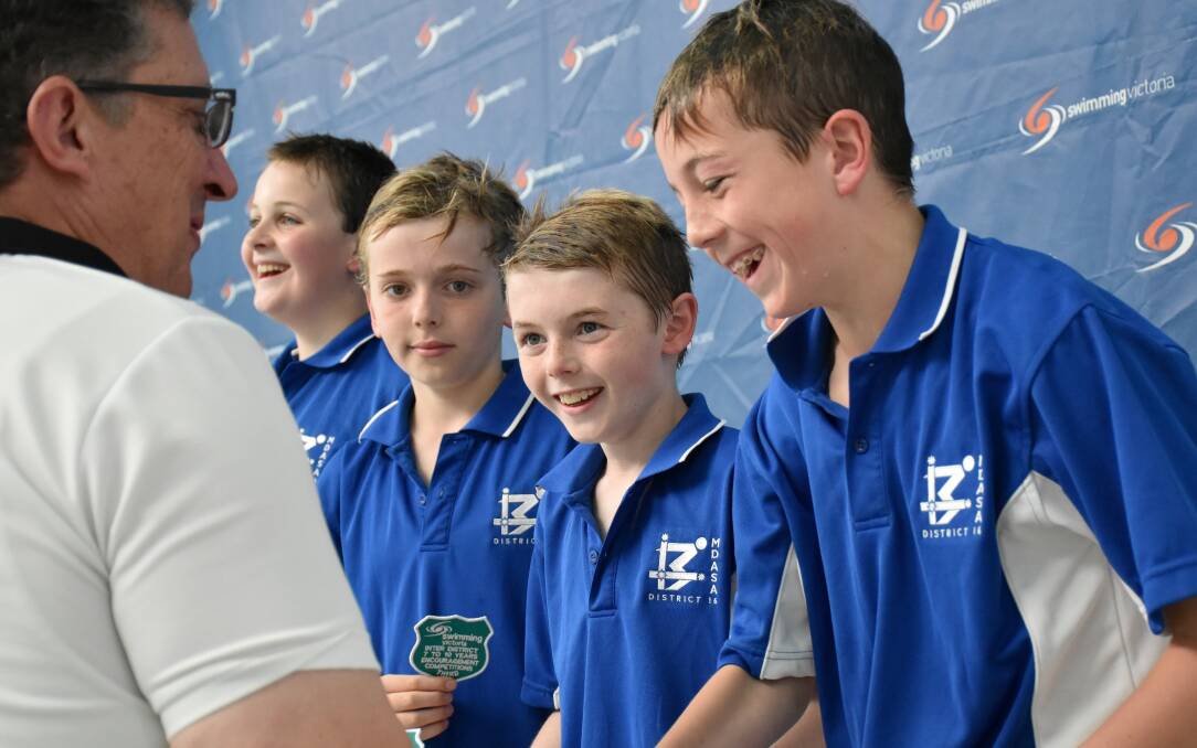 ALL SMILES: Sam Stoneman, Lachie Tilley, Edward Meddings and Max Mason receive their third place patches for the 10/under boys' medley relay.