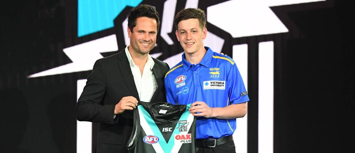 NEW COLOURS: Former Port Adelaide captain and premiership player Gavin Wanganeen with the newly drafted Zak Butters. Picture: AAP Images