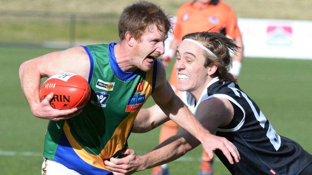 North Ballarat City youngster Ollie Nash does his best to stop Lake Wendouree raging bull Nick Peters at Mars Stadium. Picture: Kate Healy
