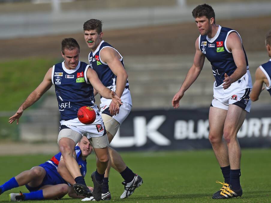 NUMBERS: Chris Giampaolo has plenty of support with Lane Buckwell, centre, and Ryan Hobbs with Ballarat finding space.