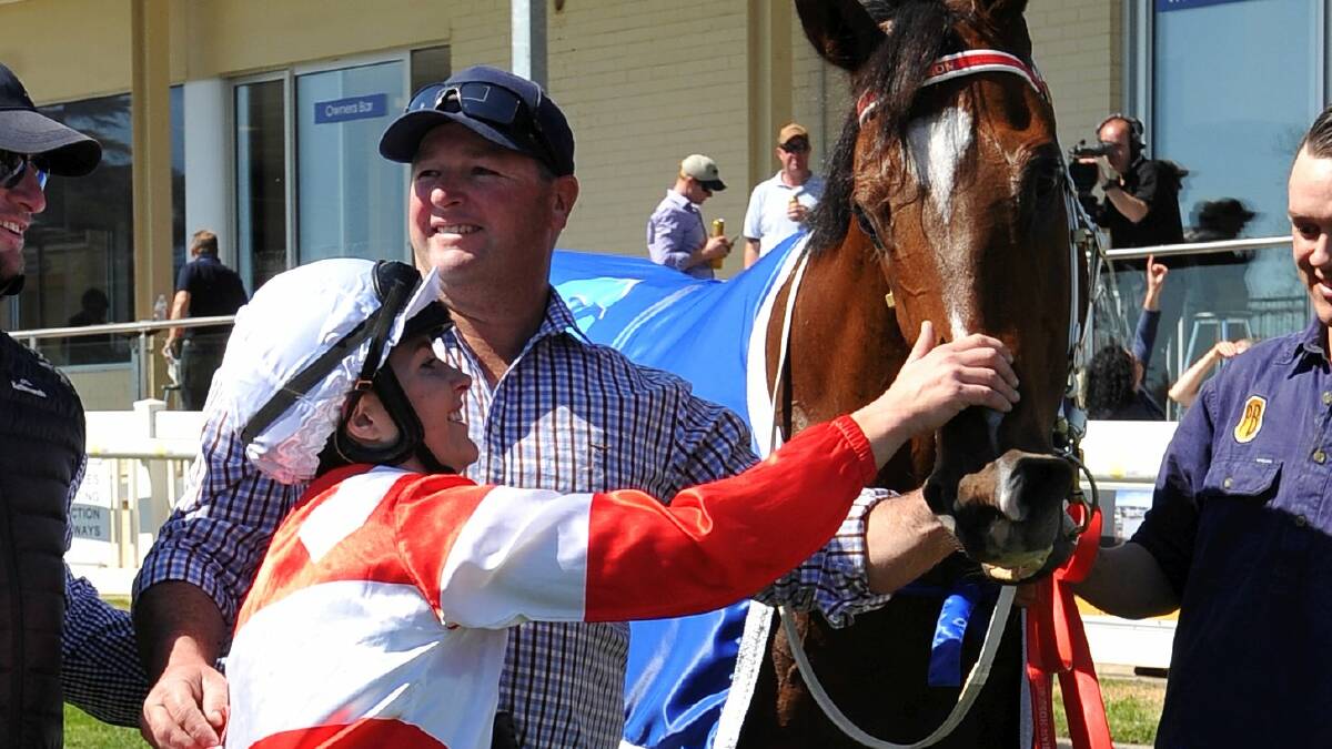 EXCITED: Chelsea Macfarlane gives Henry’s Affair a big pat after taking out the $75,000 Hotham. Picture: Lachlan Bence  