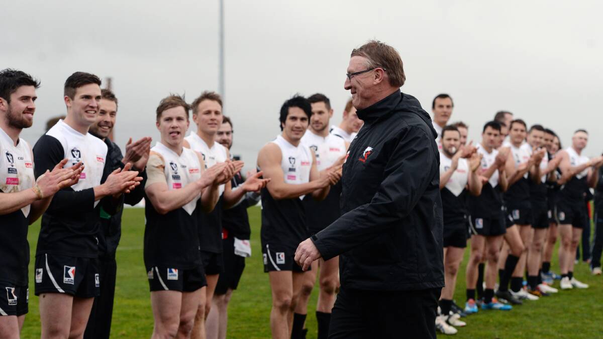 FAREWELL: Gerard FitzGerald is applauded off by his players after his last game as North Ballarat Roosters coach in 2015.