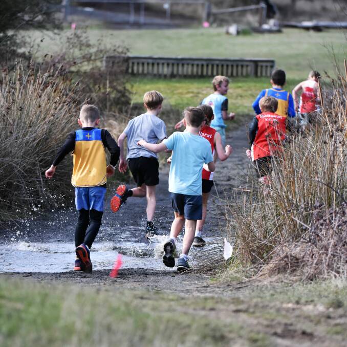 WET FEET: Youngsters tackle a water hazard.