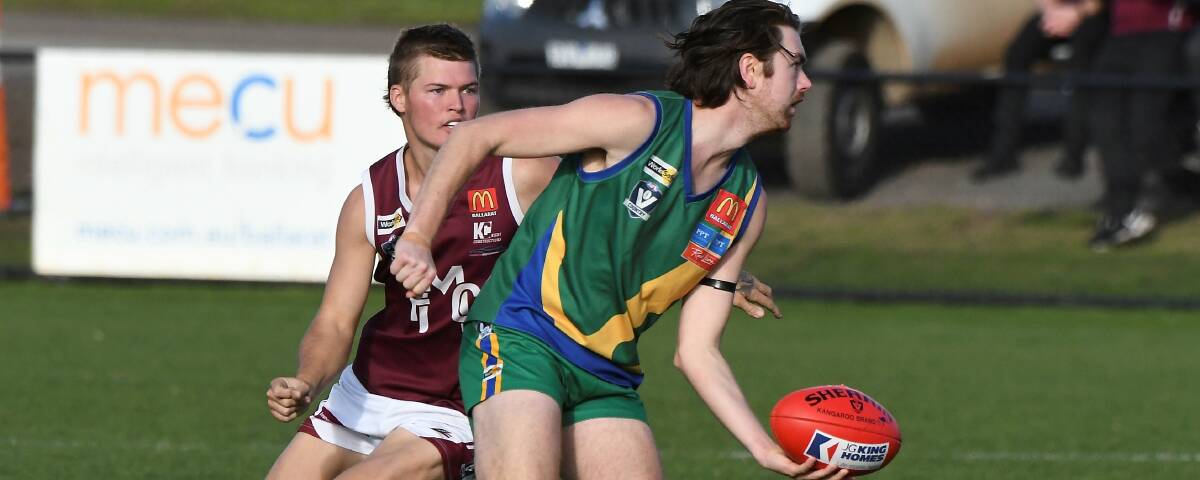 Oliver Yeung (Lake Wendouree) gets a break on Melton's Connor Griffith at CE Brown Reserve. Picture: Lachlan Bence