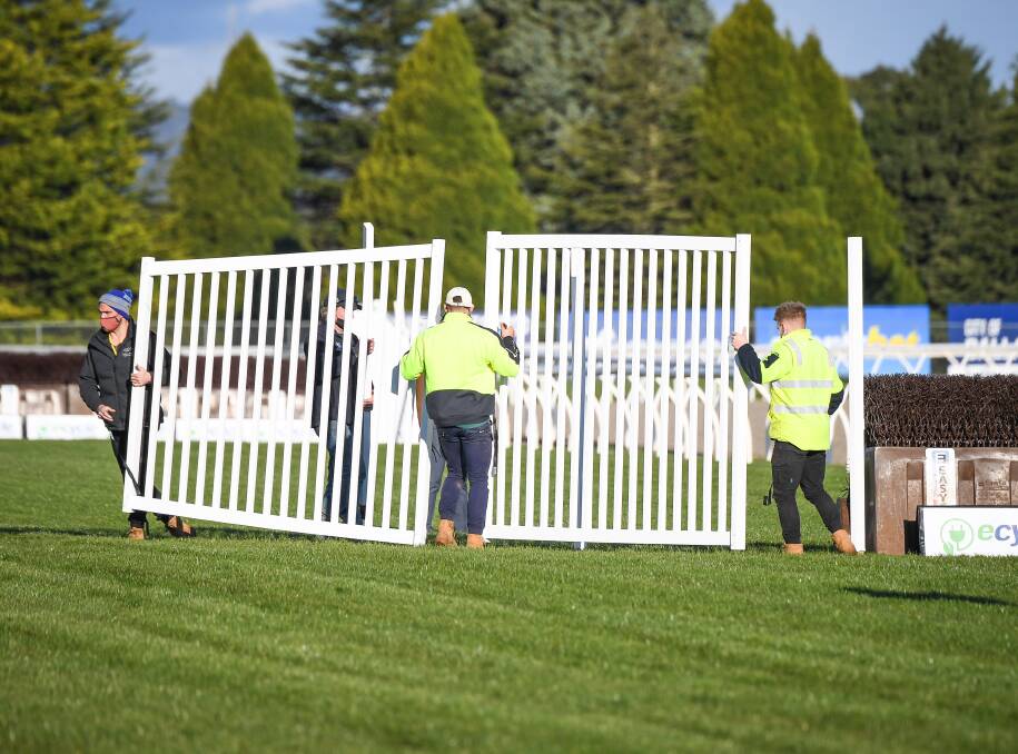 CHANGE: Ballarat Turf Club track staff removes jumps in the home straight before the Grand National Steeplechase on Sunday. Picture: Racing Photos