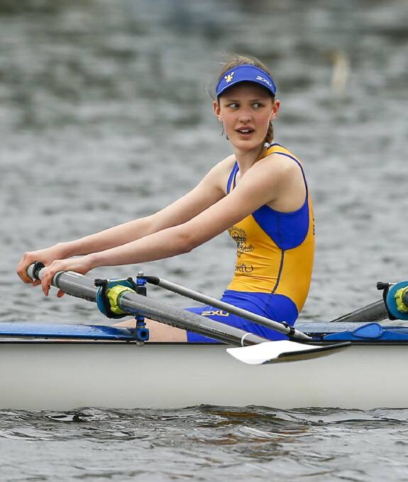 SIZING UP RIVALS: Elissa Dunn (Loreto College) checks out the opposition in a coxed quad scull event. 