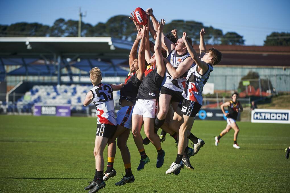 Bacchus Marsh and North Ballarat City players gets numbers this aerial contest. Picture: Luka Kauzlaric