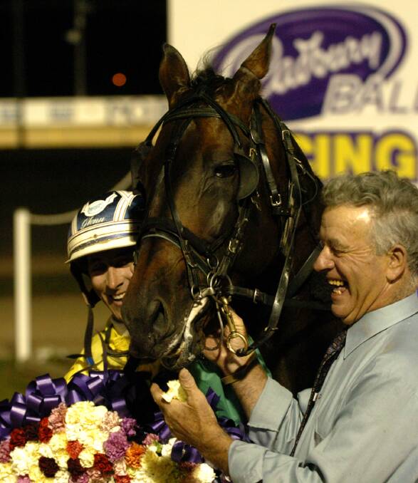 Brian Tuddenham celebrates Sting Like Bee's Ballarat Pacing Cup win with driver Daryl Douglas. Picture by The Courier.