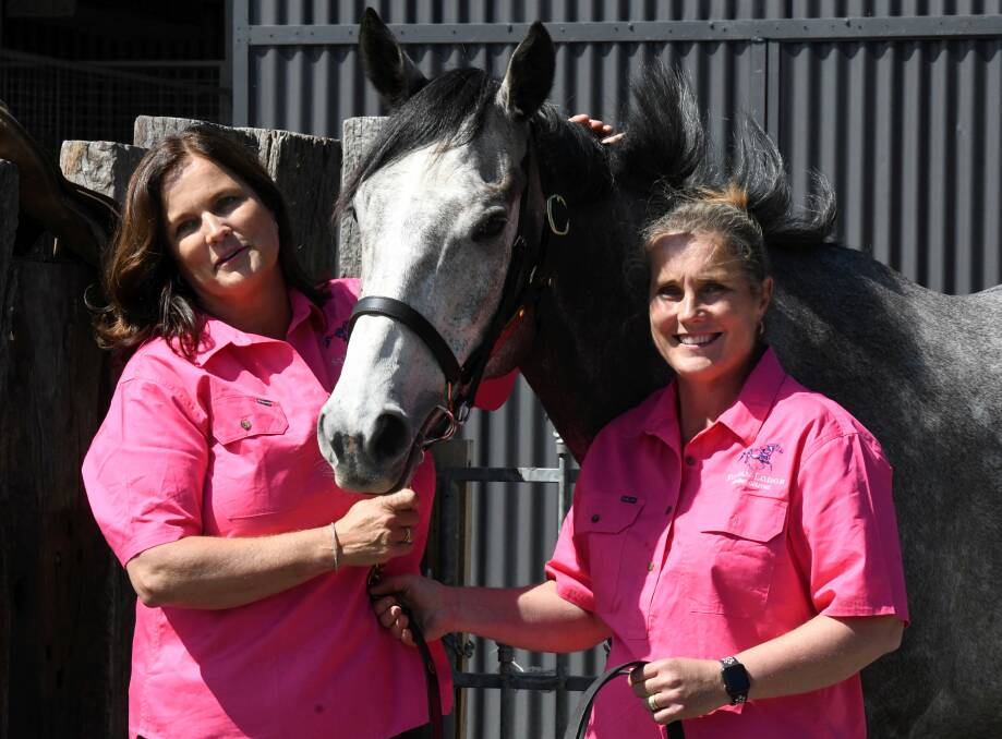 FAMILY TIES: Anita Frawley and Kelly Amoore in the well known James stable cerise colours with family favourite Captain Arjento at "Sylvan Lodge". Picture: Lachlan Bence