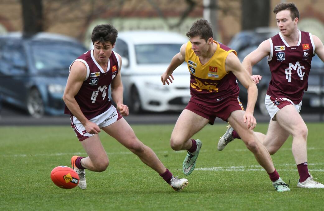 Melton's Jack Walker prepares to swoop on the football at the City Oval. Picture: Lachlan Bence