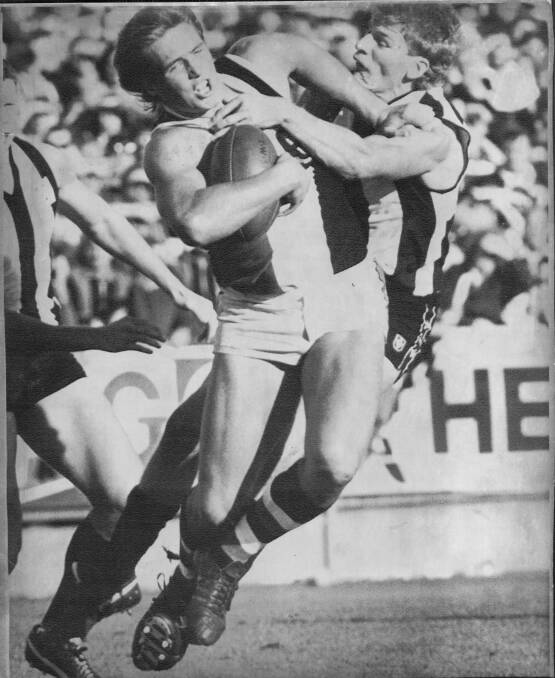 POWER PLAY: Tony Lockett uses his brute strength to fend off Collingwood's Michael Christian back in his St Kilda days.
