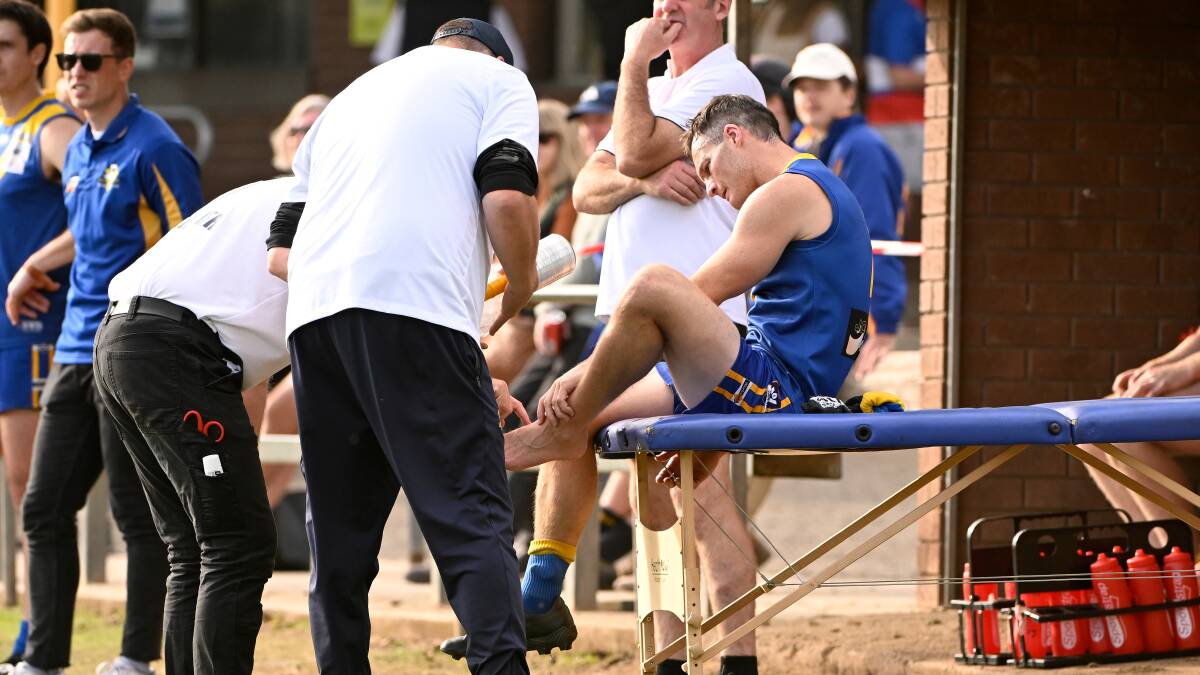 Learmonth training staff examine Brenton Powell's ankle, which was later x-rayed. Picture by Adam Trafford.
