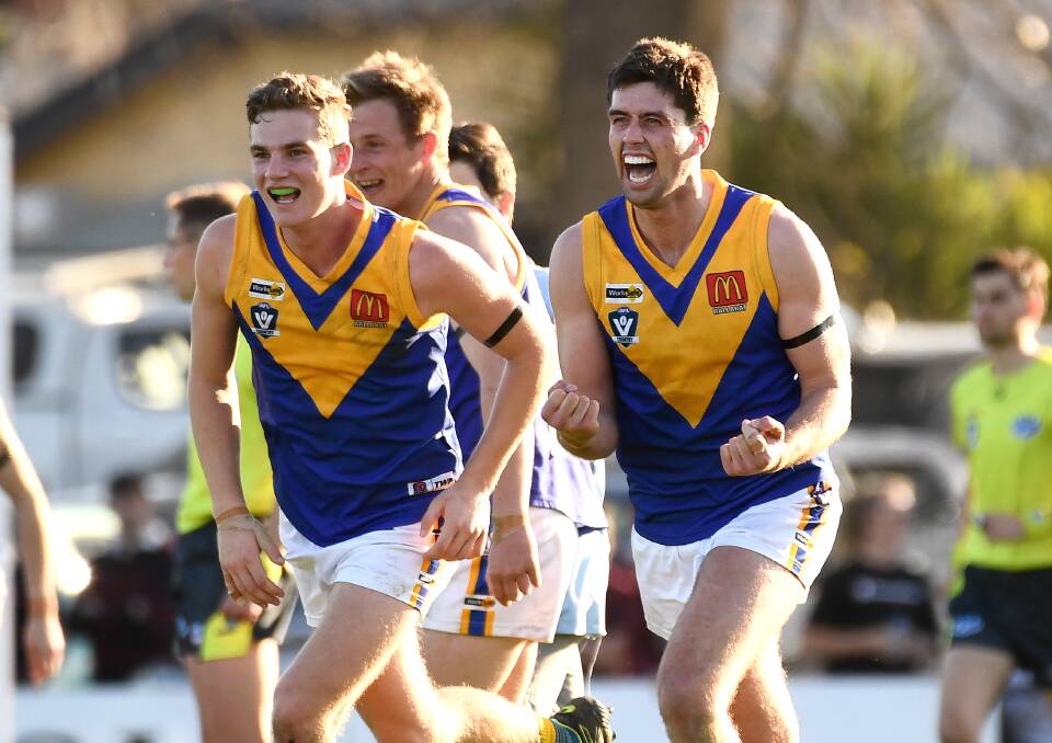 LET THE CELEBRATIONS BEGIN: Ben Hutt, left, and Tony Lockyer run to teammates on the final siren. Picture: Adam Trafford