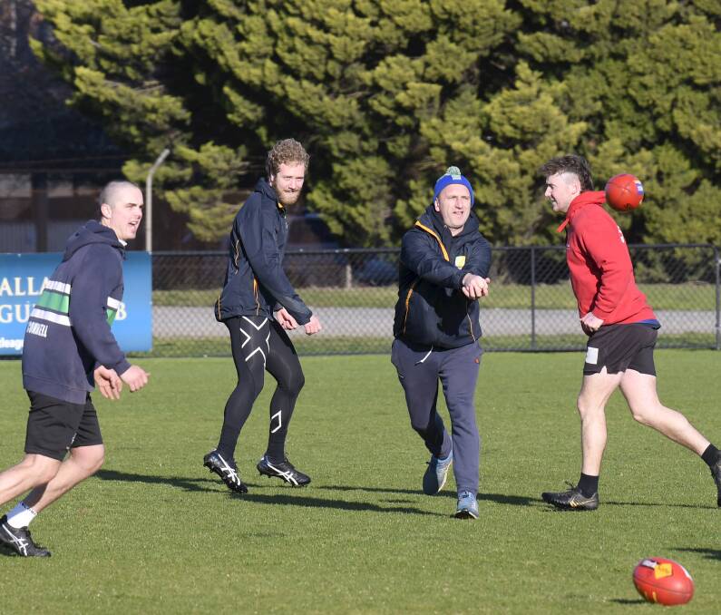 SOCIAL DISTANCING: Lake Wendouree coach Dale Power works with Lachie O'Connell and Hamish Robertson at training on Saturday. Picture: Lachlan Bence