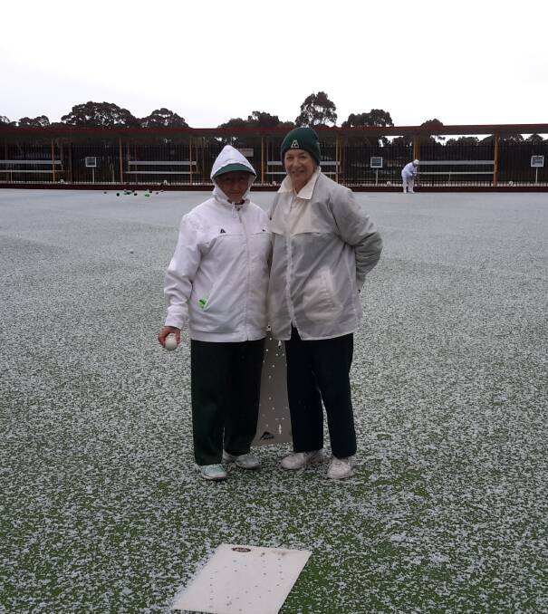BEATEN BY ELEMENTS: Webbcona’s Jenny Shepherd and Helen Williams rugged up on a hail covered green at Creswick.  