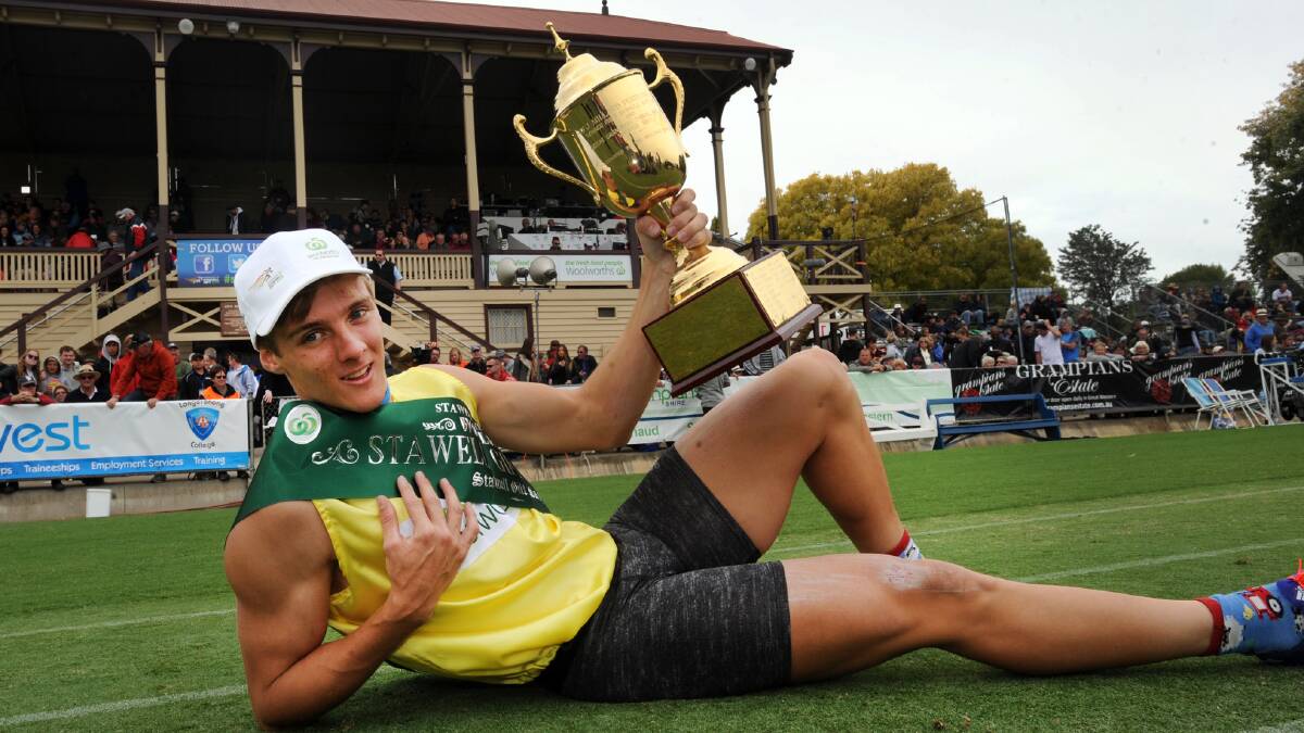 IT'S MINE: Isaac Dunmall soaks up all that goes with winning the $60,000 Stawell Gift final at Central Park on Monday. Picture: Paul Carracher