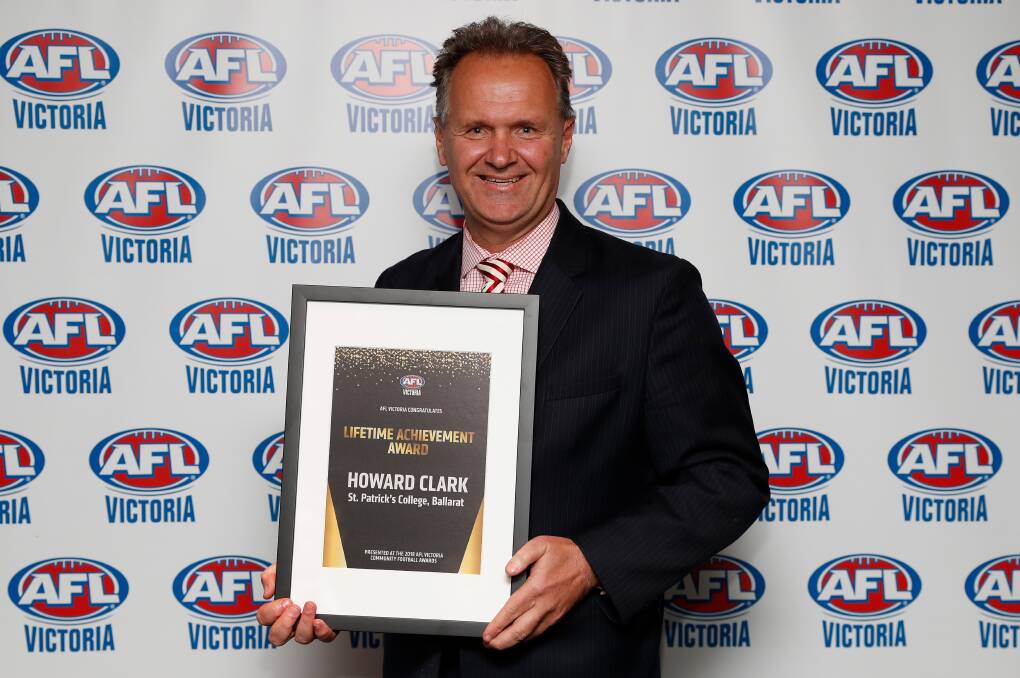 HONOURED: Howard Clark with the Allan Jeans Lifetime Achievement Award. Picture: AFL Victoria 